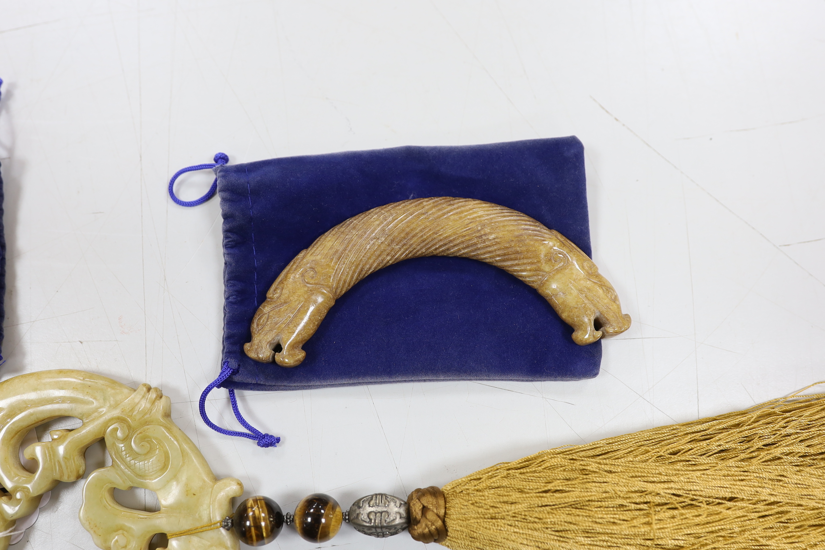 Three Chinese jade carvings, two huang, a large hardstone pendant and disc, largest overall 90cm in length (4)